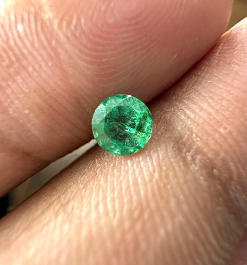 Angled View of Faceted 4.3mm Round Cut Natural Emerald