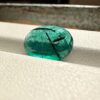 Visual size reference showing the large 3.60 carat oval emerald resting on a hand, perfect for a bespoke statement ring.