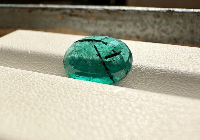 Visual size reference showing the large 3.60 carat oval emerald resting on a hand, perfect for a bespoke statement ring.