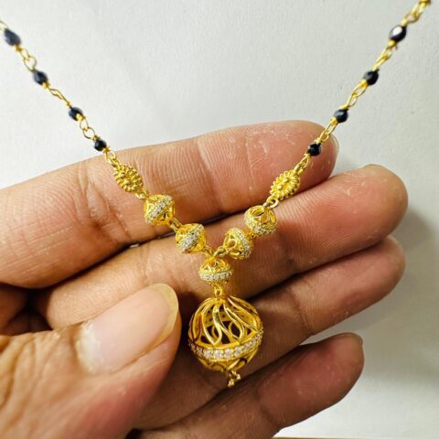 18k Gold Mangalsutra Pendant Held in Hand Size Reference