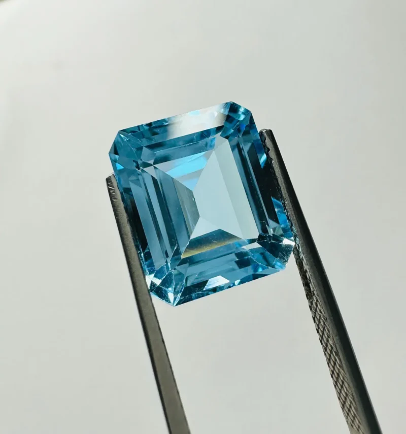Loose Sky Topaz Gemstone Held in Tweezers for Custom Jewelry