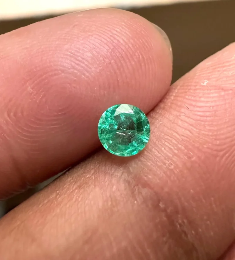 Loose Vivid Green Emerald Held in Tweezers for Engagement Ring