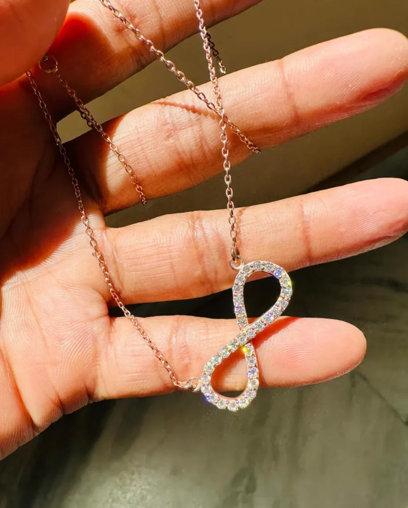 Infinity Moissanite Pendant Necklace Held in Hand Size Scale